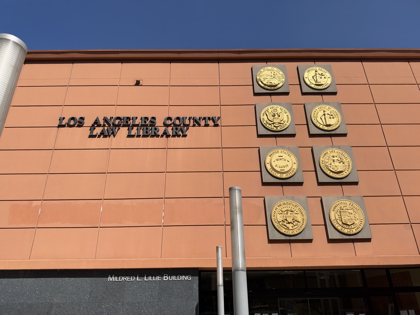 The Los Angeles County Law Library facade, with its name in raised letters beside eight gold seals of the California and federal courts